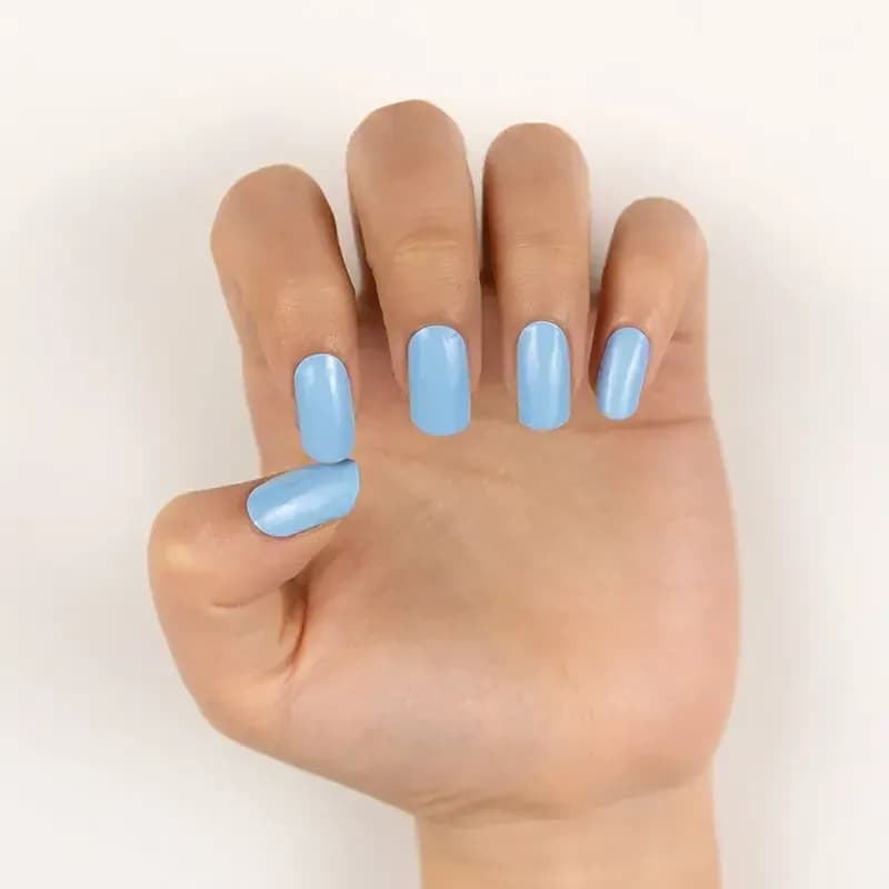 Cloud Nine sky blue gel nails, close up on a curled hand
