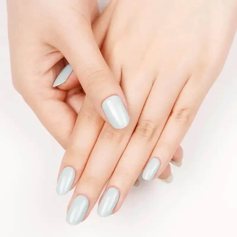 Coastal Breeze pale blue gel nails on softly crossed hands