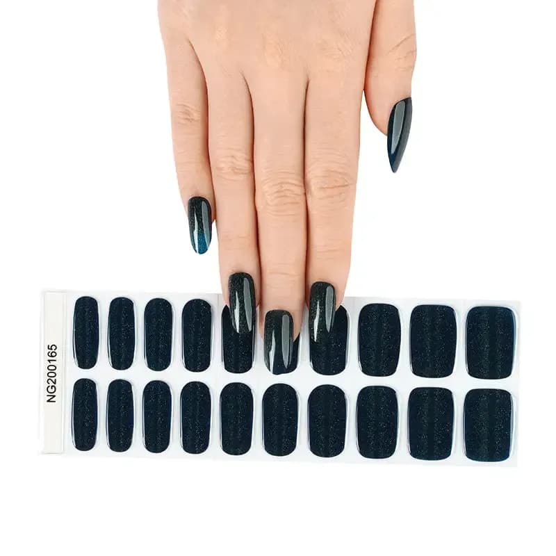 Emerald Twinkle dark green glitter gel nail strips, the full 20-strip sheet under a manicured hand