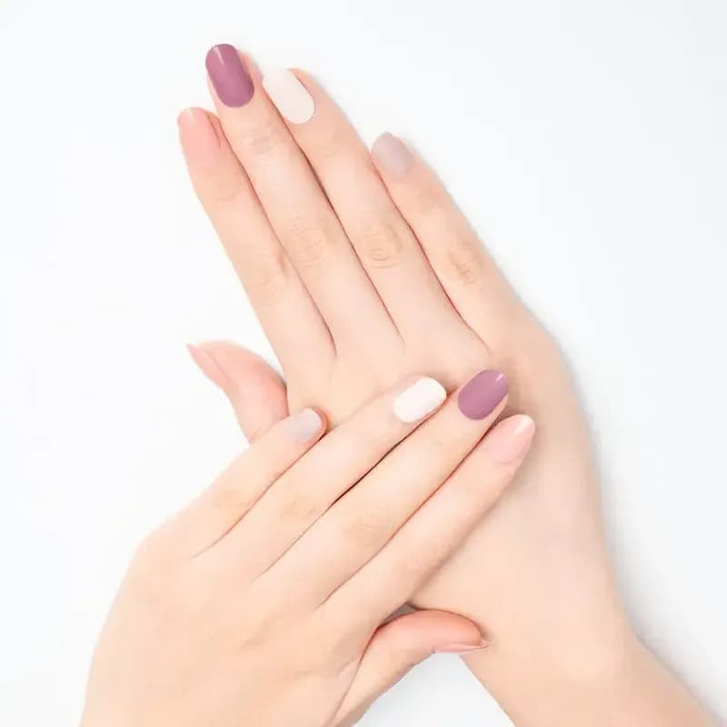 Neutral Harmony mixed neutral gel nails in mauve, blush and cream on crossed hands