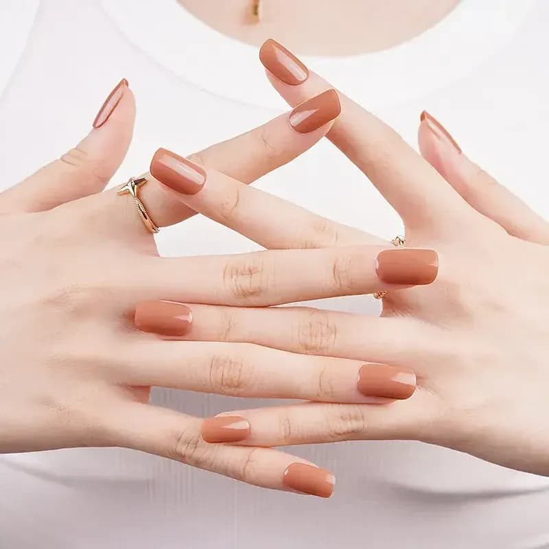 Nude Blossom warm terracotta nude gel nails shown on crossed hands