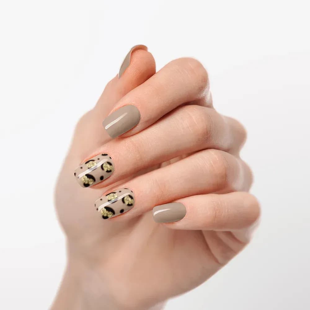 Nude Safari leopard print gel nail strips worn on curled fingers