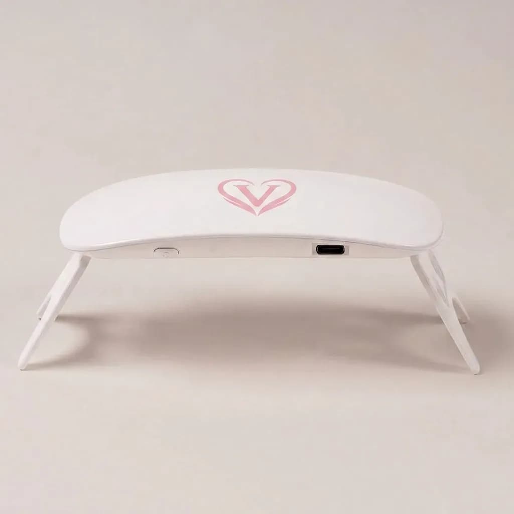 Velvora pink UV LED nail lamp side view showing the fold-out legs and USB-C port