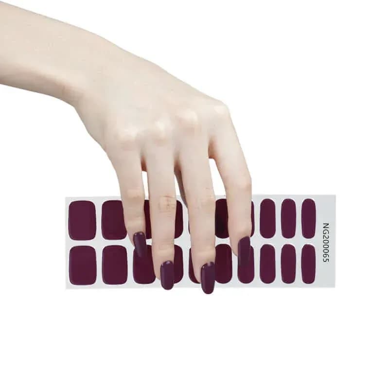 Royal Plum deep plum gel nail strips, the full 20-strip sheet under a manicured hand