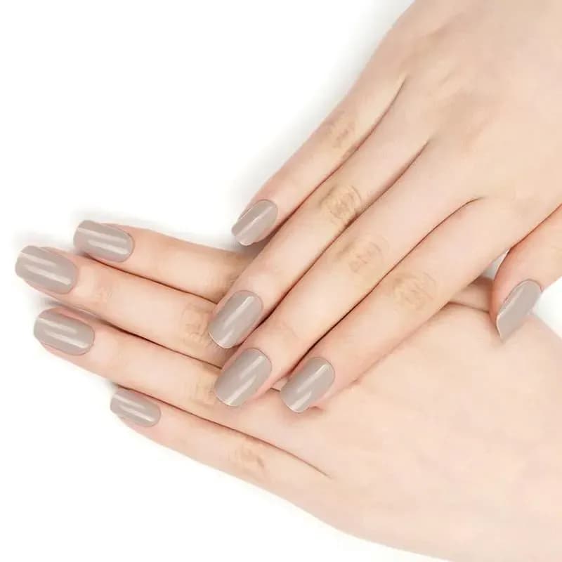 Timeless Taupe greige gel nails shown on softly crossed hands