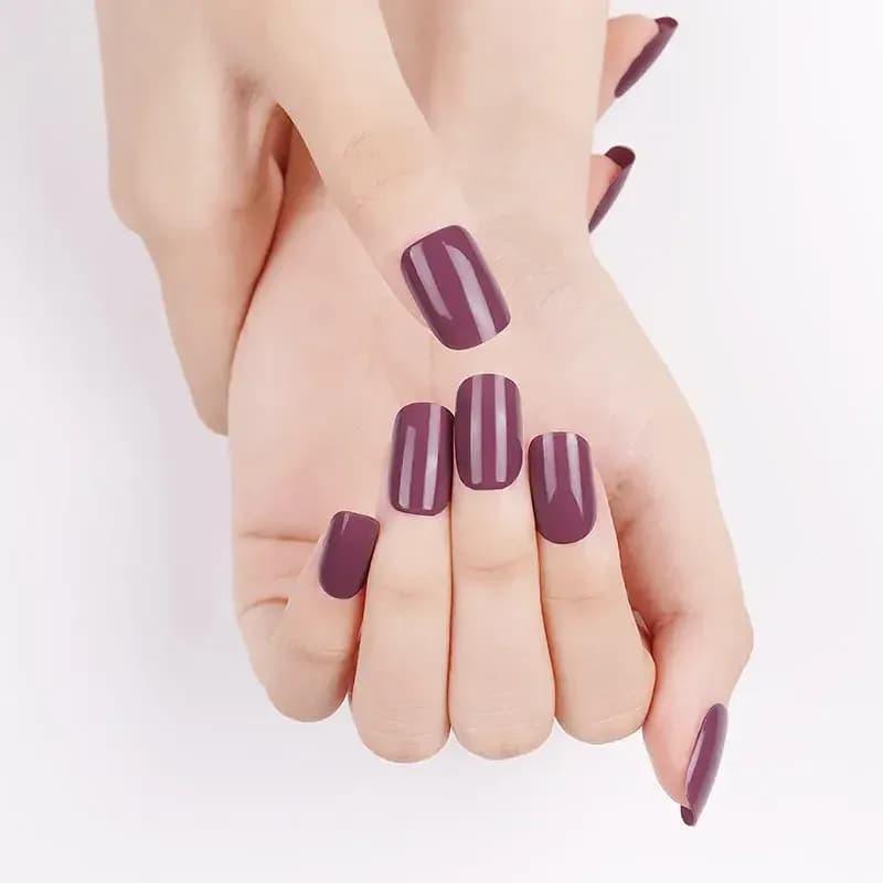 Vintage Rose dusty mauve gel nails shown on a softly curled hand