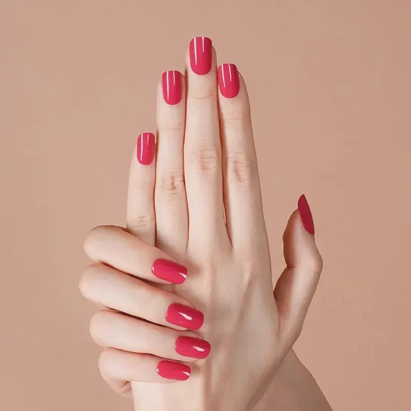 Wild Orchid raspberry pink gel nails shown on raised hands