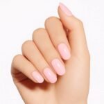 Hand showing semi-cured gel nail strips in Pink Blush