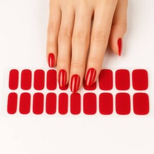 A close-up of a hand wearing deep red semi-cured gel nail wraps in an almond shape, with a full set of matching nail strips displayed on a white background – Velvet Rouge by Velvora.