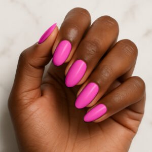 Close-up of hand with almond-shaped nails wearing glossy electric pink semi-cured gel nail strips – bold neon manicure for statement at-home nails.
