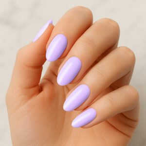 Hand with almond-shaped nails wearing glossy lavender purple semi-cured gel nail strips – soft pastel manicure for a dreamy, spring-inspired at-home nail look.