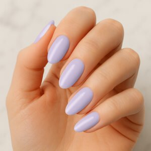 Hand with almond-shaped nails wearing glossy lavender purple semi-cured gel nail strips – soft pastel manicure for a fresh spring-ready at-home nail look.