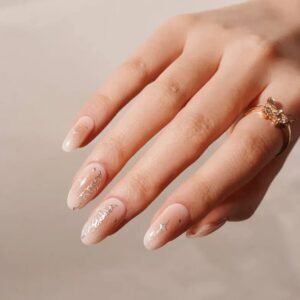 Close-up of Velvora Celestial Aura semi-cured gel nail strips with nude base, silver sparkle accents and celestial designs – UK handmade look