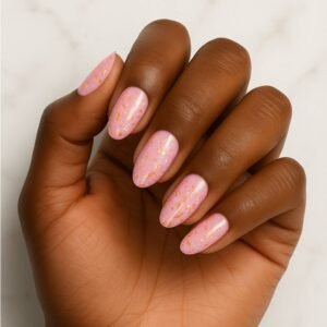 Velvora Cosmic Pink semi-cured gel nail strips with pink base and gold foil flecks on almond-shaped nails, product photo for UK customers.