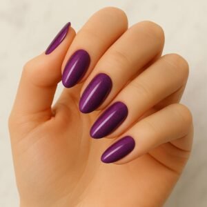 Velvora Dahlia semi-cured gel nail strips in rich purple with subtle shimmer on almond-shaped nails, product photo for UK customers