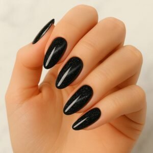 Velvora Galactic Noir semi-cured gel nail strips in deep black with subtle galaxy shimmer on almond-shaped nails, product photo for UK customers