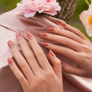 Velvora Love Script semi-cured gel nail strips on blush-nude nails with white heart line art – romantic manicure
