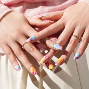 Both hands with Velvora Tie-Dye rainbow nail wraps against sunlight.