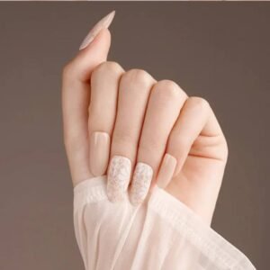 Hand partly covered by chiffon sleeve, showcasing Vintage Lace wraps in soft studio lighting.