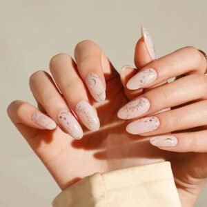 Both hands with Velvora Zodiac Dreams gel nail wraps in blush pink with astrology and moon phase accents – buy online in the UK