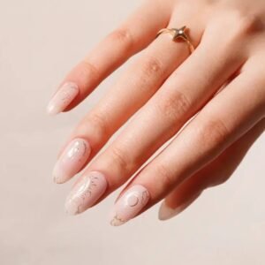 Close-up of Zodiac Dreams semi-cured gel nail strips by Velvora featuring gold celestial and zodiac designs on soft blush base – UK product